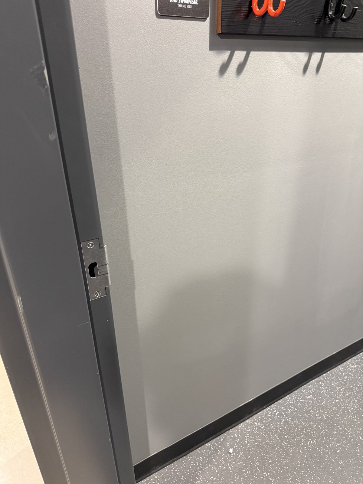 Painted fitting-room wall after patching and touch-up